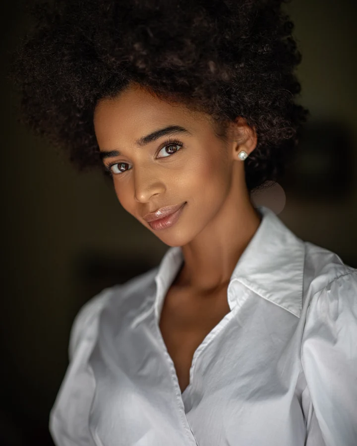 Beauty portrait of a smiling woman with natural hair in a white shirt